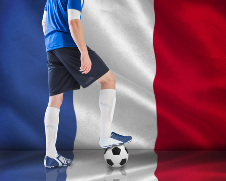 Composite image of football player standing with ball against digitally generated france national flagの写真素材