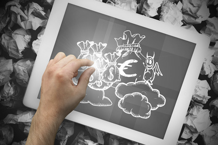 Composite image of hand touching tablet showing devil with money bags doodleの写真素材