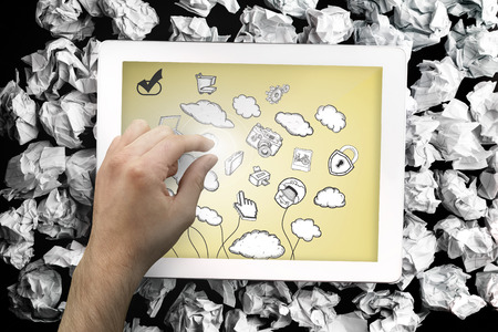 Composite image of hand touching tablet showing cloud computing doodleの写真素材