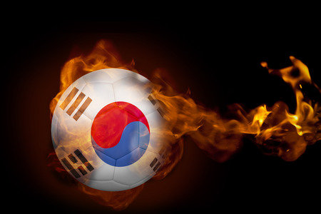 Composite image of fire surrounding korea republic ball against blackの写真素材
