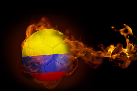 Composite image of fire surrounding colombia ball against blackの写真素材