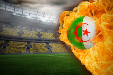 Composite image of fire surrounding algeria flag football against large football stadium with lightsの写真素材