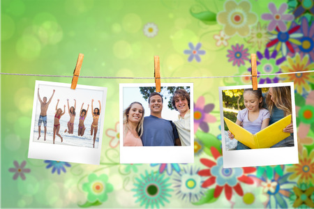Composite image of instant photos hanging on a line against green floral designの写真素材