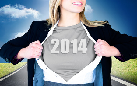 Businesswoman opening shirt in superhero style against road leading out to the horizon