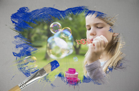 Composite image of little girl blowing bubbles with paintbrush dipped in blue against digitally generated grey backgroundの写真素材