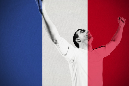 Excited football fan cheering against france national flagの写真素材