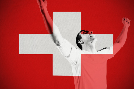 Excited football fan cheering against switzerland national flagの写真素材
