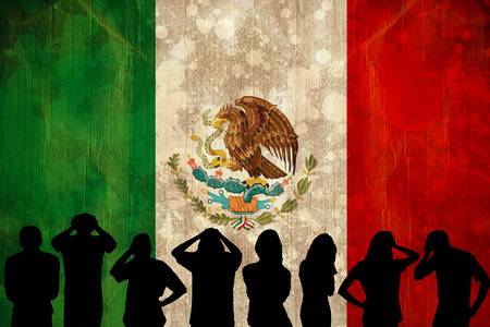 Silhouettes of football supporters against mexico flag in grunge effectの写真素材