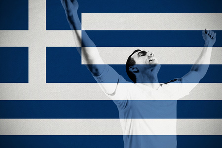 Excited football fan cheering against greece national flagの写真素材