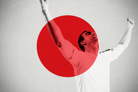 Excited football fan cheering against japan national flagの写真素材