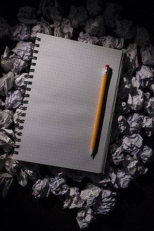 Graph paper notebook with pencil on dark backgroundの写真素材