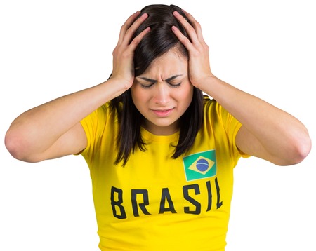 Upset football fan in brasil tshirt on white backgroundの写真素材