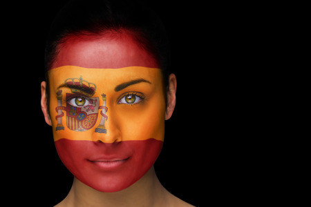 Composite image of spanish football fan in face paint against blackの写真素材