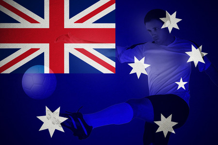 Football player in yellow kicking against football in brazilian coloursの写真素材