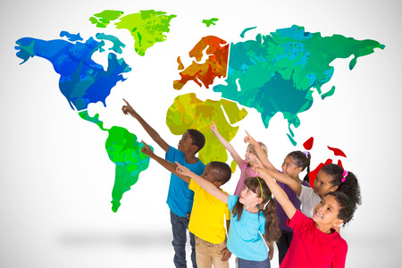 Elementary pupils pointing against white background with vignette with world mapの写真素材