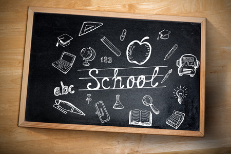 Composite image of education doodles against chalkboard