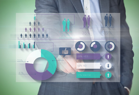 Composite image of businessman in grey suit pointing against green vignetteの写真素材