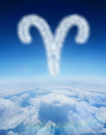 Cloud in shape of aries star sign against blue sky over clouds at high altitudeの写真素材
