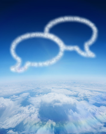 Cloud in shape of speech bubbles against blue sky over clouds at high altitudeの写真素材
