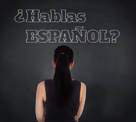 Composite image of standing businesswoman against blackboardの写真素材