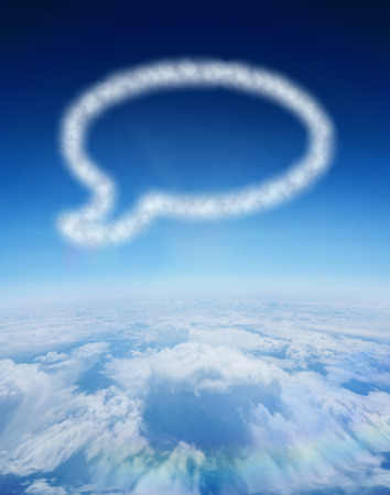 Cloud in shape of speech bubble against blue sky over clouds at high altitudeの写真素材