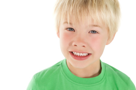 Cute little boy smiling at camera on white background