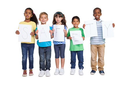 Cute children showing safety message to camera on white backgroundの写真素材