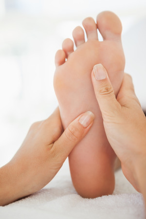 Woman receiving a foot massage at the health spaの写真素材