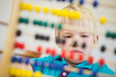 Cute pupil using abacus in classroom at the elementary schoolの写真素材