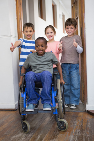 Disabled pupil with his friends in classroom at the elementary schoolの写真素材
