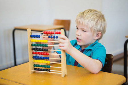 Cute pupil using abacus in classroom at the elementary schoolの写真素材