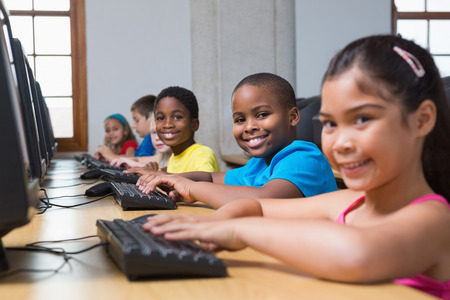 Cute pupils in computer class at the elementary schoolの写真素材