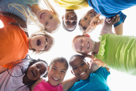 Cute pupils smiling down at camera outside at the elementary schoolの写真素材
