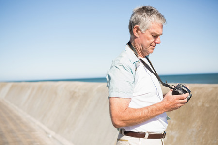Happy senior man looking at his camera on a sunny dayの写真素材