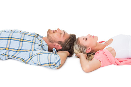 Attractive young couple sleeping peacefully  on white backgroundの写真素材