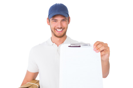 Happy delivery man holding cardboard box and clipboard on white background