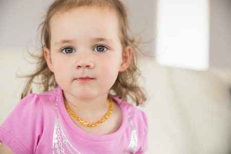 Close up portrait of a cute little girl at homeの写真素材