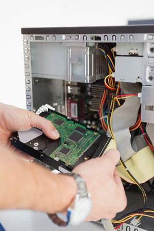 Computer engineer working on broken cpu in his officeの写真素材