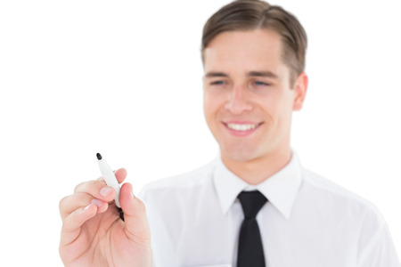 Nerdy businessman writing with black marker on white backgroundの写真素材