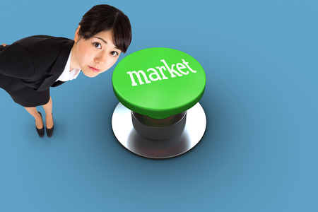 The word market and serious businesswoman bending against blue background