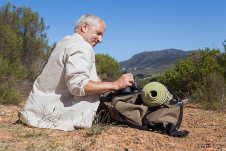 Hiker taking a break on country trail on a sunny dayの写真素材