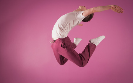 Cool break dancer mid air in the dance studio