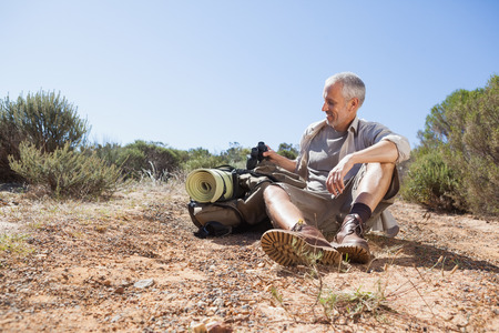 Hiker taking a break on country trail on a sunny dayの写真素材