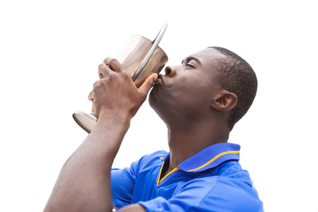 Football player in blue kiss winners cup on white backgroundの写真素材
