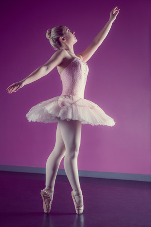 Graceful ballerina dancing en pointe in the ballet studioの写真素材