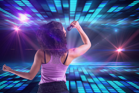 Pretty girl singing against digitally generated cool disco design 
