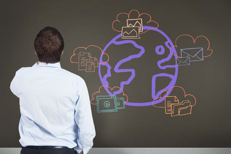 Businessman against room with wooden floor with business technology doodleの写真素材