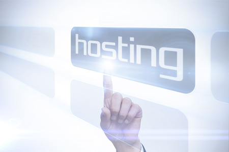 Businessman pointing to word hosting against white background with vignetteの写真素材