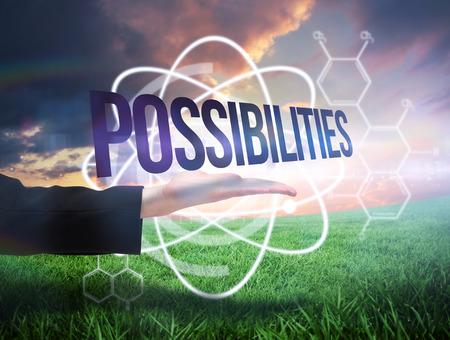 Businesswomans hand presenting the word possibilites against green field under orange skyの写真素材