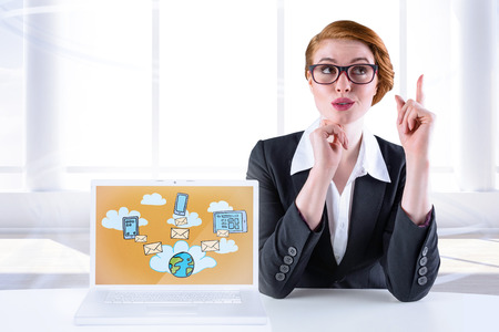 Thinking redhead businesswoman against bright room with windowの写真素材